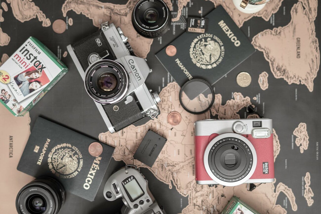 top view of cameras and passports on a map